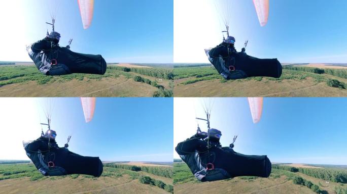 男运动员用滑翔机训练，飞越田野。