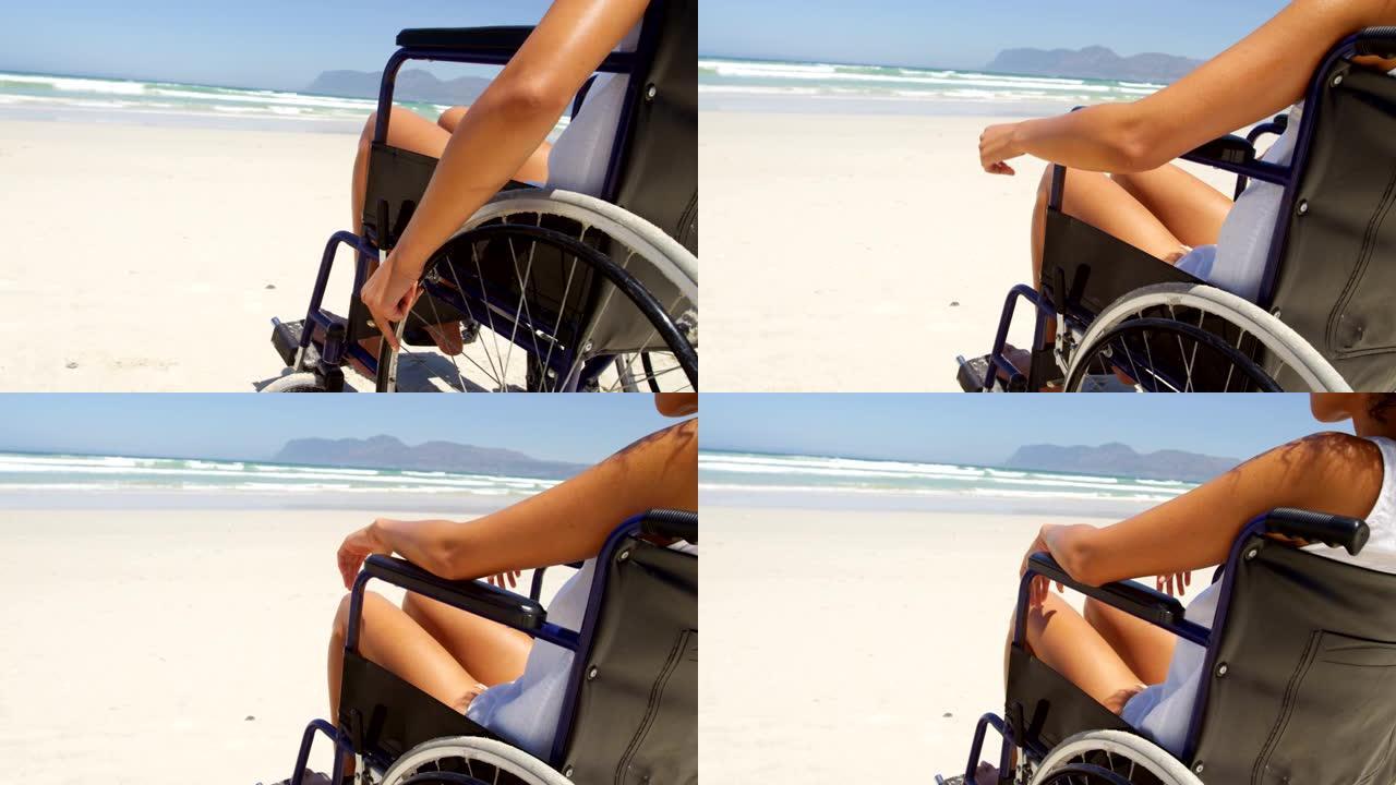 坐在4k海滩轮椅上的残疾妇女