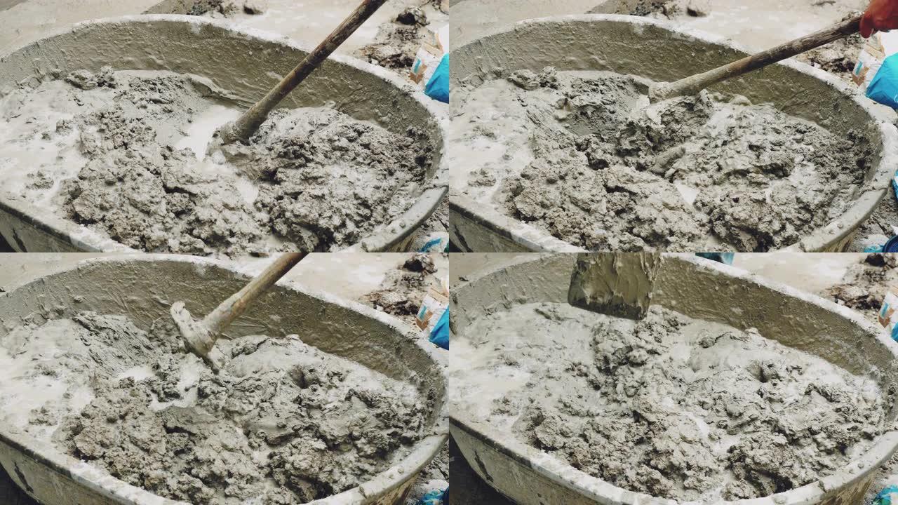 将水泥与水混合用于建筑施工的工人