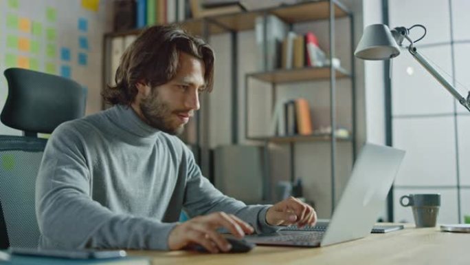 英俊的长发西班牙裔商人坐在办公室的办公桌前，用笔记本电脑工作。创意开发新软件独角兽启动项目，完成业务