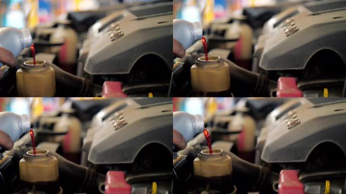 慢动作: 机械工程师将机油更换到发动机中进行维修和保养