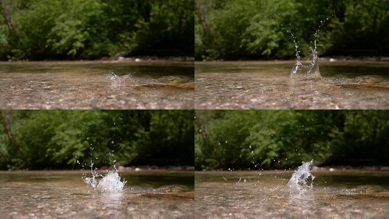 慢动作: 岩石落入浅山河流的电影镜头。