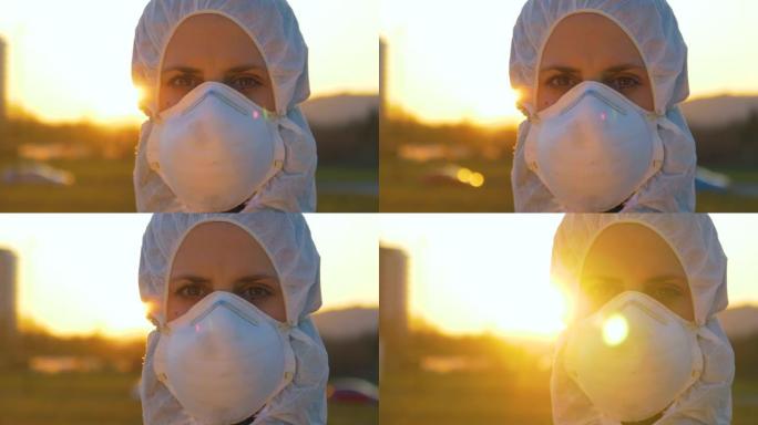 身穿冠状病毒面罩和西装的肖像女人在日落时看着相机