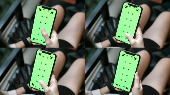 使用带色度键的智能手机的特写手女人，显示的模拟绿屏