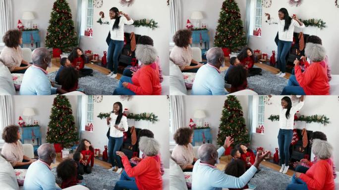 多代家庭一起在家庆祝圣诞节时玩猜字谜游戏