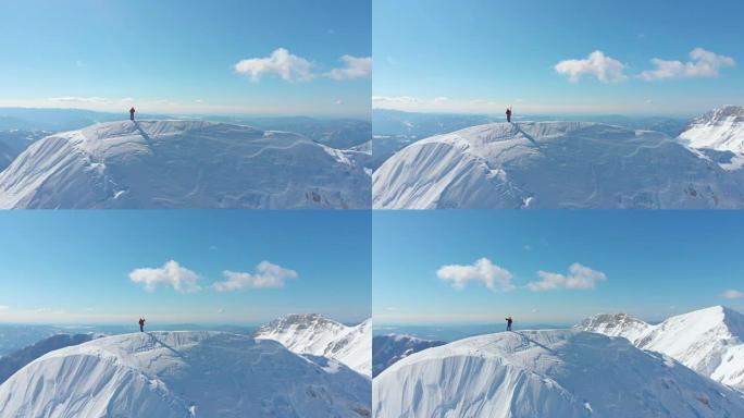 空中: 壮观的晴天山脉环绕滑雪者拍摄自然照片