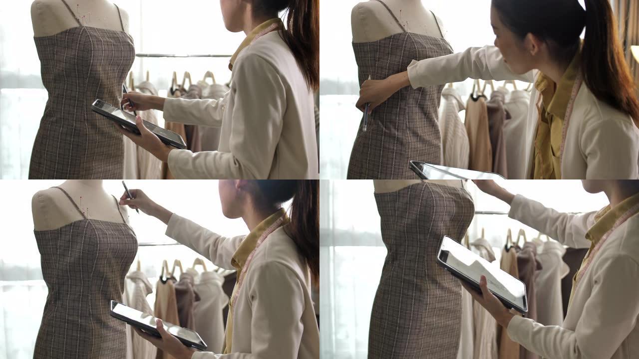 亚洲服装设计师女士正在使用数字平板电脑