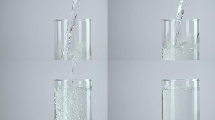慢动作: 将水倒入白色背景的水杯中。
