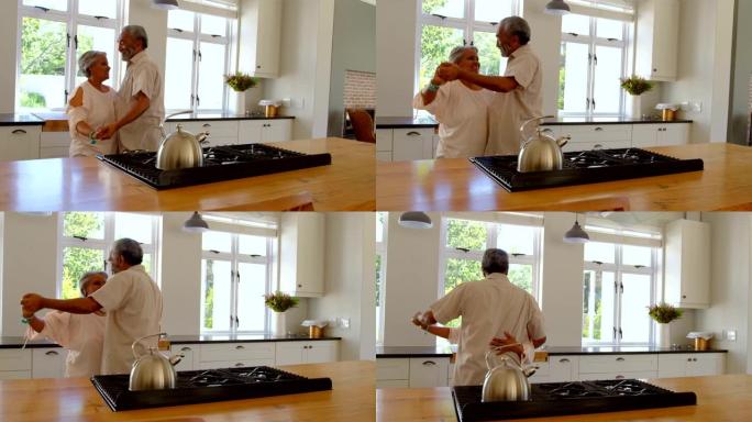 高级黑人夫妇在舒适的家庭4k厨房里一起跳舞的侧视图