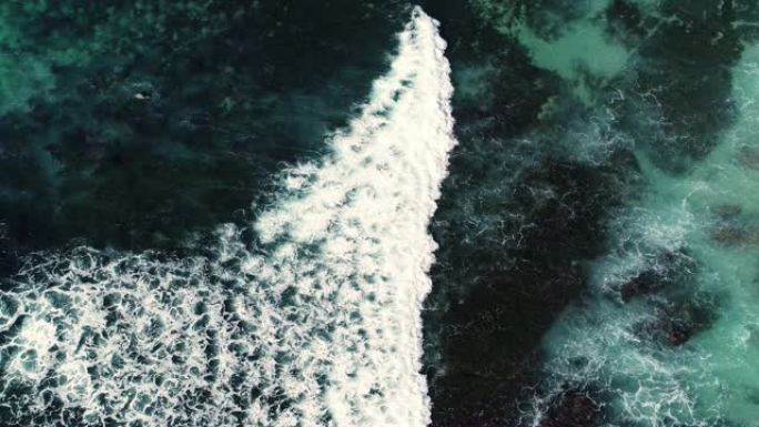 海浪撞击海岸线的俯视抽象鸟瞰图