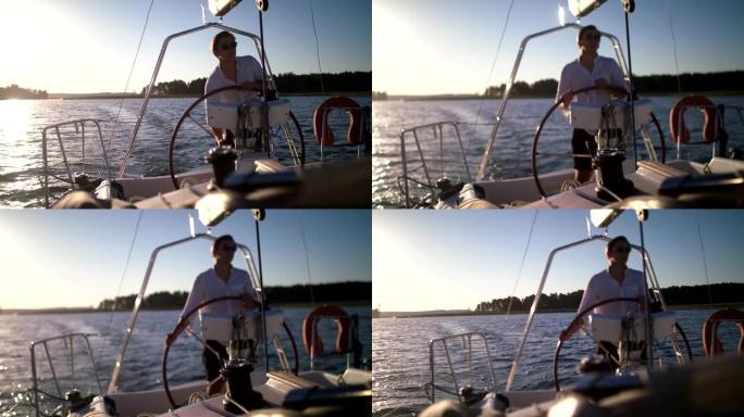 湖上宁静的日落。享受帆船运动的年轻人