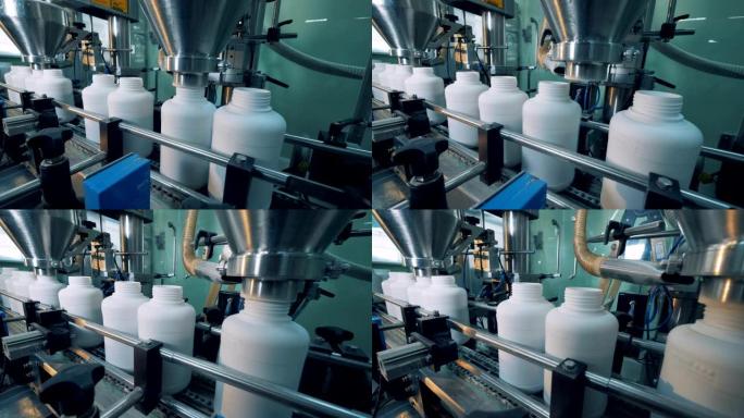 工厂机器灌装塑料瓶，自动工艺。
