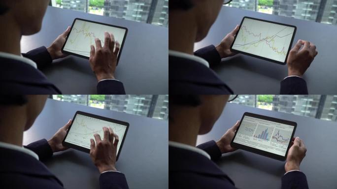 商人用手触摸数字平板电脑进行分析图