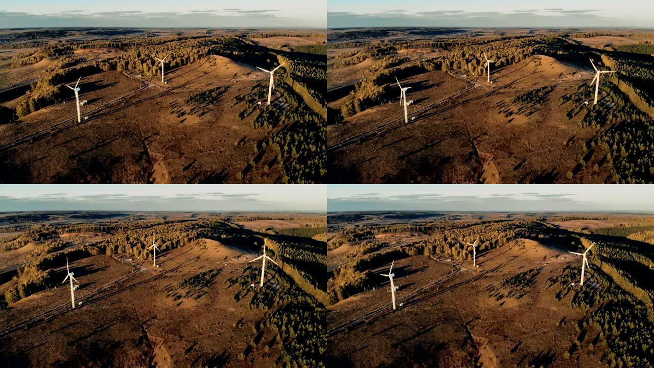 三个安装在开阔地形上的风车正在产生能量。风能、风能发电概念。