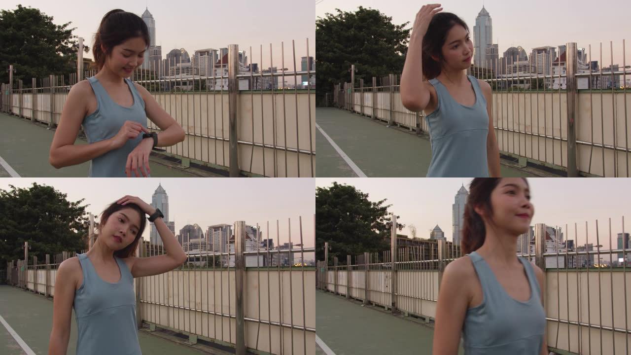 美丽的年轻亚洲运动员女士在城市环境中锻炼伸展运动。