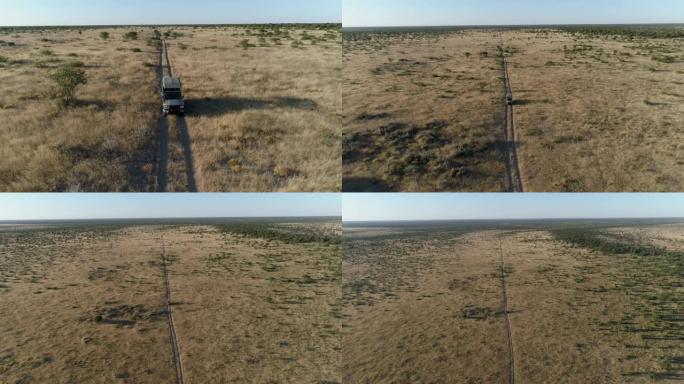 行驶在纳米比亚非洲萨凡纳草原的野生动物园车辆的4k高空中缩小视图