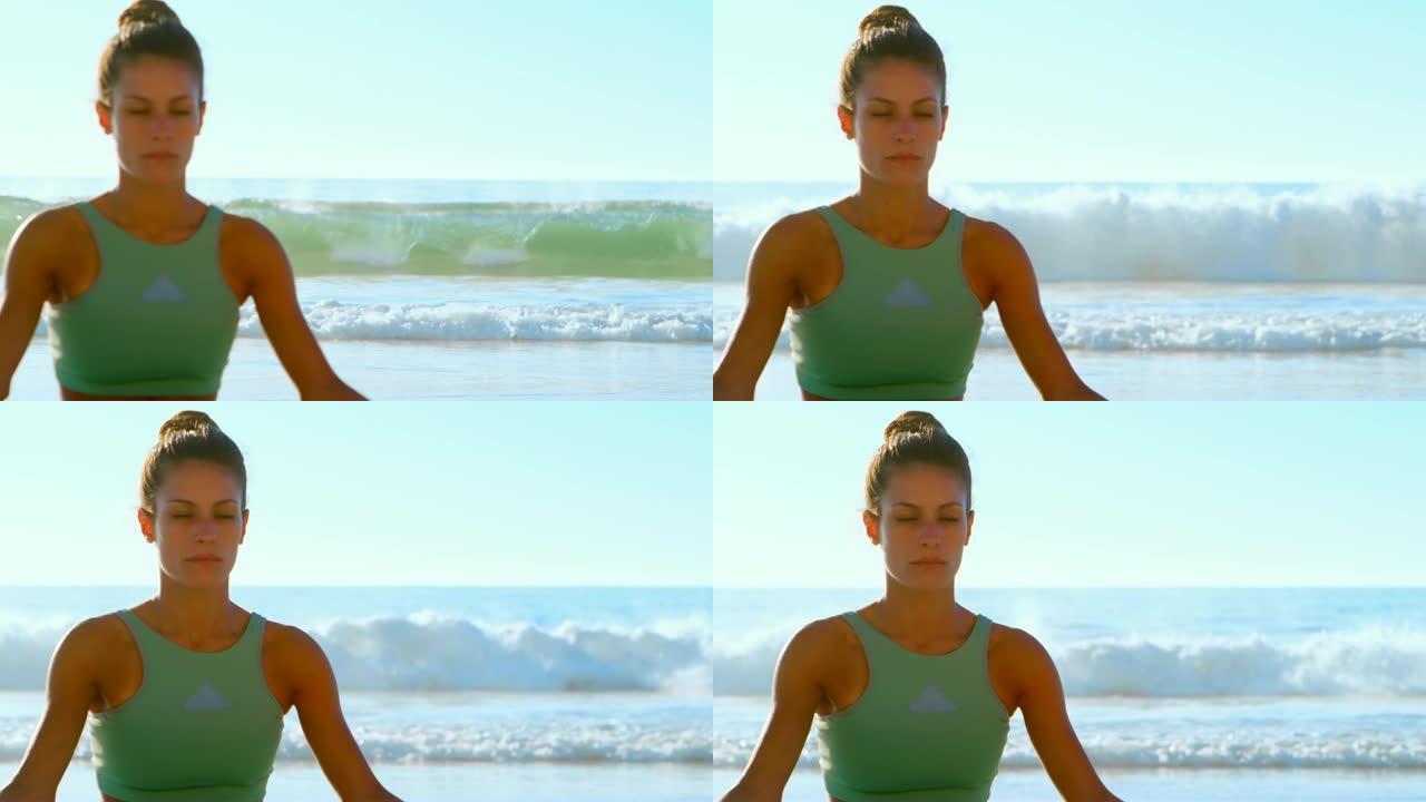 在4k海滩上表演瑜伽的女性