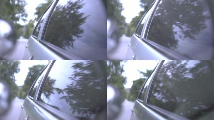 车窗上的反射。汽车驾驶的镜头，慢动作