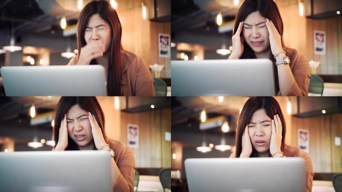 4k镜头亚洲女商人穿着休闲服在笔记本电脑前工作并患有抑郁症的场景-工作空间，商业健康和压力概念