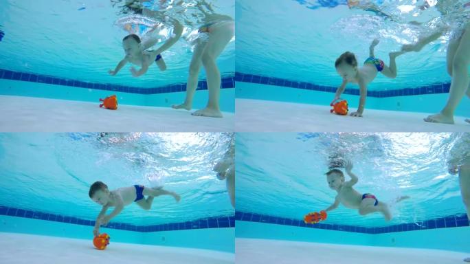 一个玩具被婴儿从游泳池底部抬起