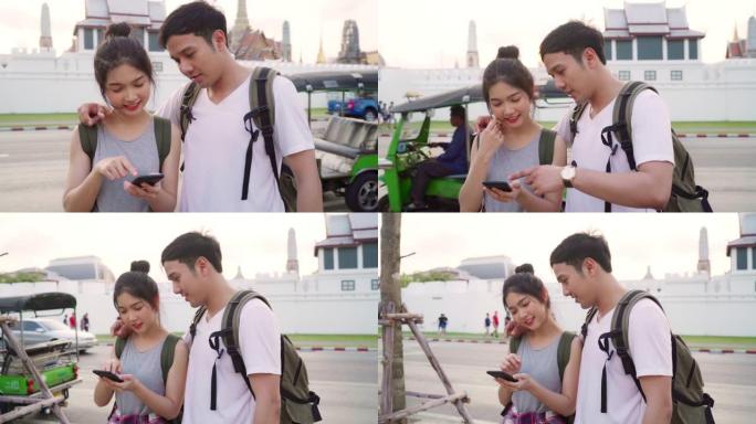 慢动作-泰国曼谷位置图上的旅行者亚洲夫妇方向，甜蜜的夫妇在日落时利用手机看地图。生活方式夫妇旅行概念