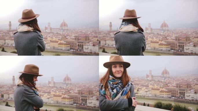 穿着暖和衣服的快乐微笑的旅游女孩享受意大利佛罗伦萨的壮丽全景，在雨天走开