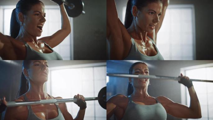 运动美女在健身房用杠铃顶起。华丽的女性专业健美运动员在硬核训练设施中进行举重锻炼。放大