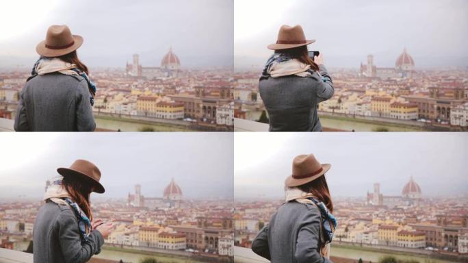 快乐的年轻女性旅行者走上前，拍摄意大利佛罗伦萨秋季惊人城市景观全景的智能手机照片。