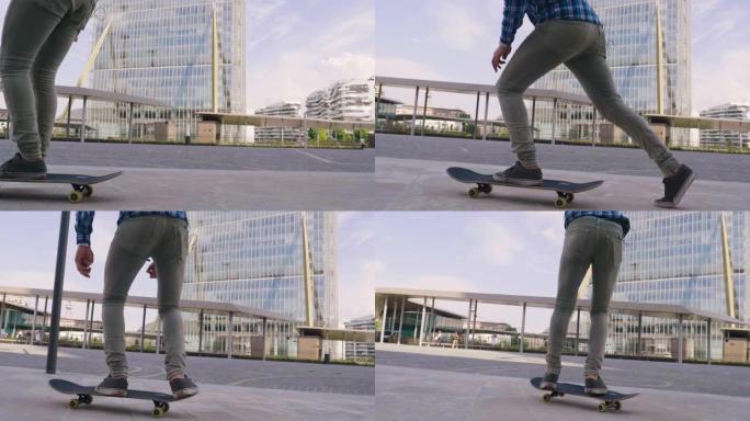 一个男孩在城市中心的建筑物和摩天大楼之间练习滑板。