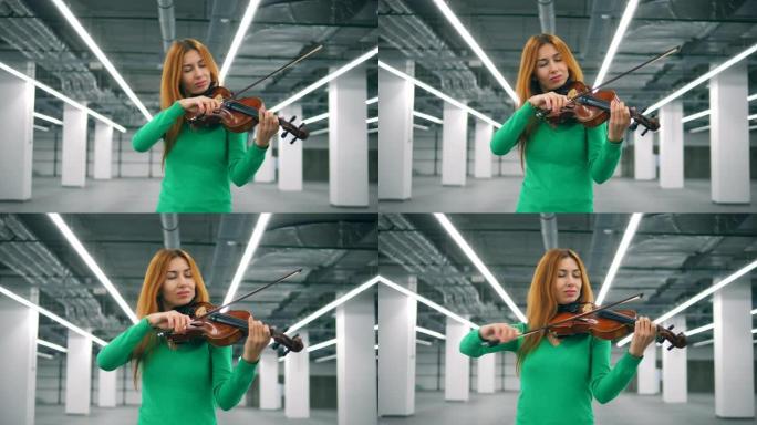 可爱的女人正在愉快地拉小提琴