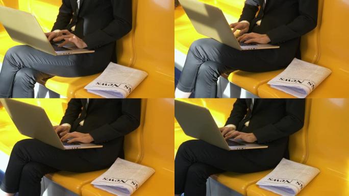 女商人使用笔记本电脑在火车上工作的特写镜头。