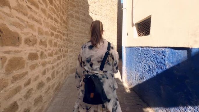时尚女人探索地中海小镇。后视