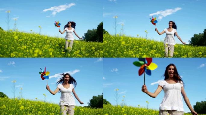 在阳光和风的日子里，一个快乐的年轻美丽的绿色女孩在新鲜风的能量的帮助下吹着五颜六色的风车。