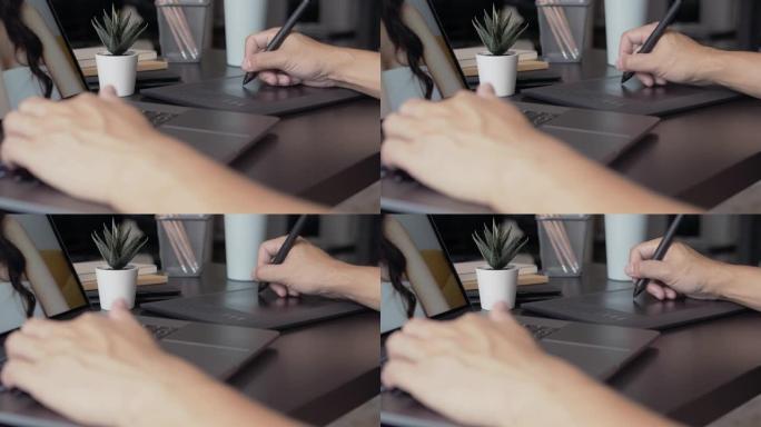 平面设计师在带有图形平板电脑的笔记本电脑上工作。润饰照片。