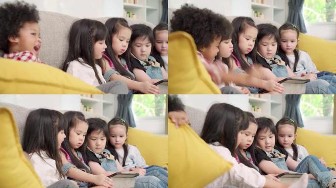 一群在教室里使用平板电脑的孩子，多民族的年轻男孩和女孩在小学里快乐地使用技术学习和玩游戏。孩子们使用