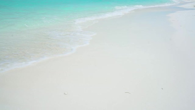 马尔代夫阳光明媚的白色沙滩上的海洋冲浪女士