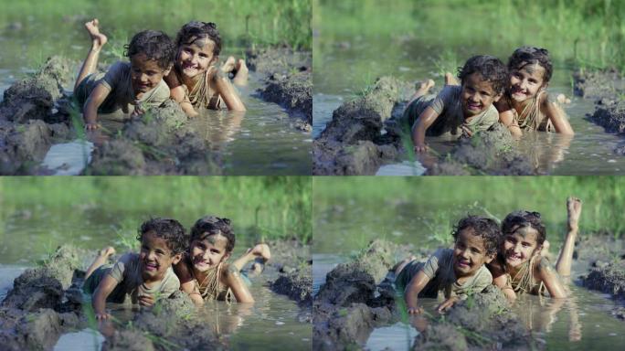 两名幼儿参加有趣的泥巴奔跑
