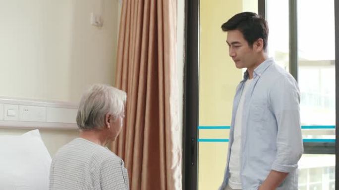 年轻的亚洲成年儿子在医院探望父亲