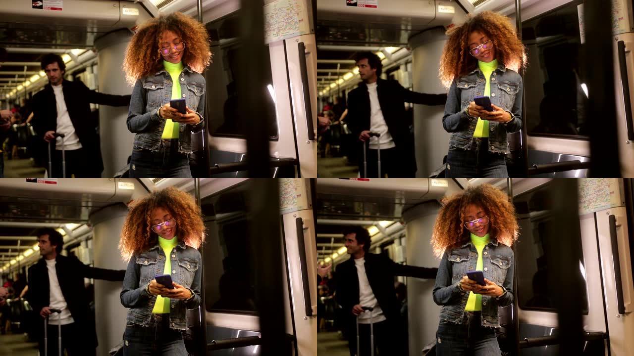 年轻的黑人妇女在火车上旅行时使用智能手机