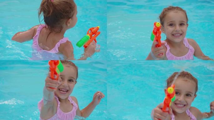 一个快乐的微笑小女孩在游泳池里玩水枪的真实时刻