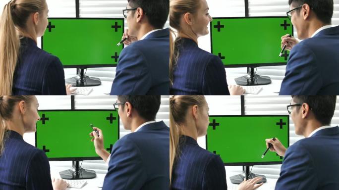 两名商务人士在办公室使用电脑绿屏