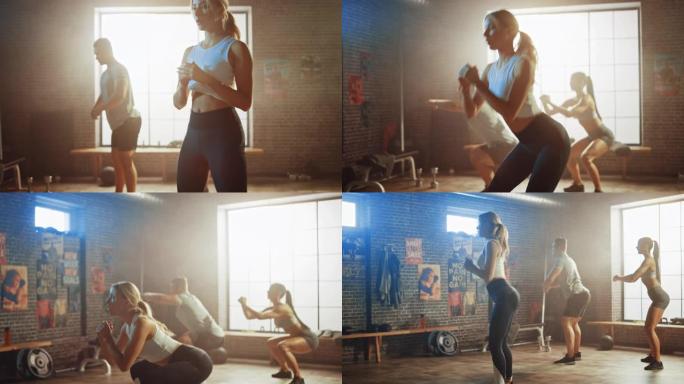 强壮的男性男人和两个健康的运动员正在做下蹲运动。他们在阁楼健身房锻炼身体，墙上贴有激励人心的海报。天