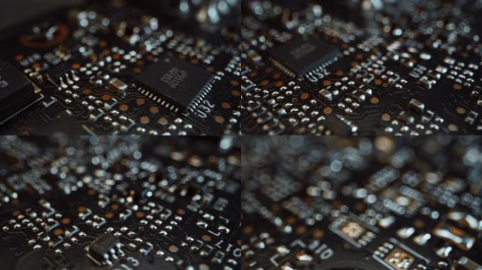 微距相机在印刷电路板上缓慢移动，显示计算机主板组件: 微芯片，CPU处理器，晶体管。电子设备内部。图