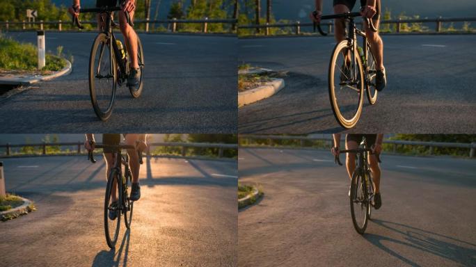 观看专业道路自行车运动员的腿，日落时踩踏板上坡