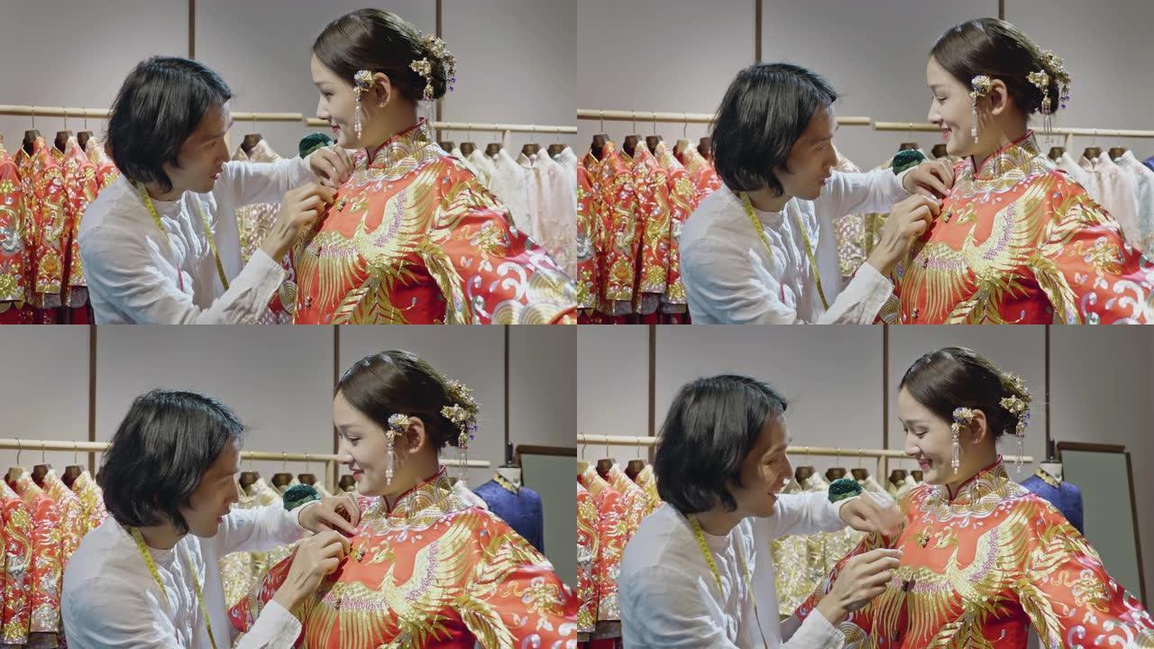 男性中国婚纱设计师在工作室为年轻新娘装扮