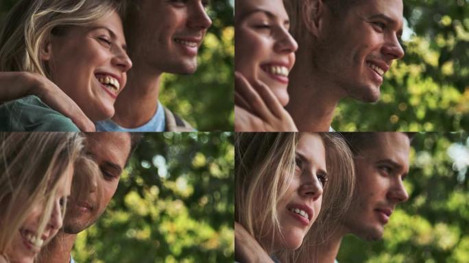 微笑的年轻夫妇在森林中拥抱