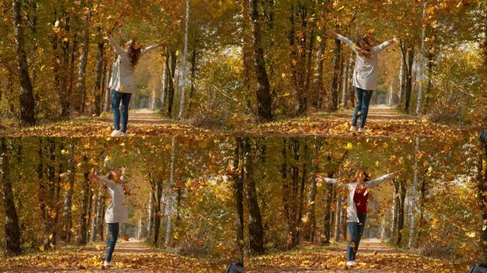 慢动作: 女孩在空气中扔了一堆干燥的叶子后伸出手臂