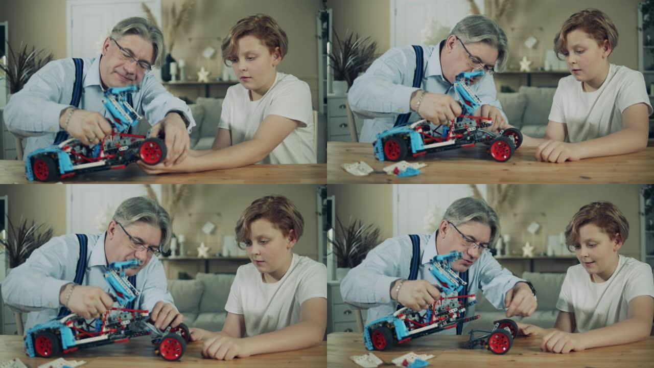 高年级男子正在和他的孙子组装一辆玩具车