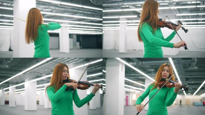 红发女人在空荡荡的大厅里熟练地拉小提琴