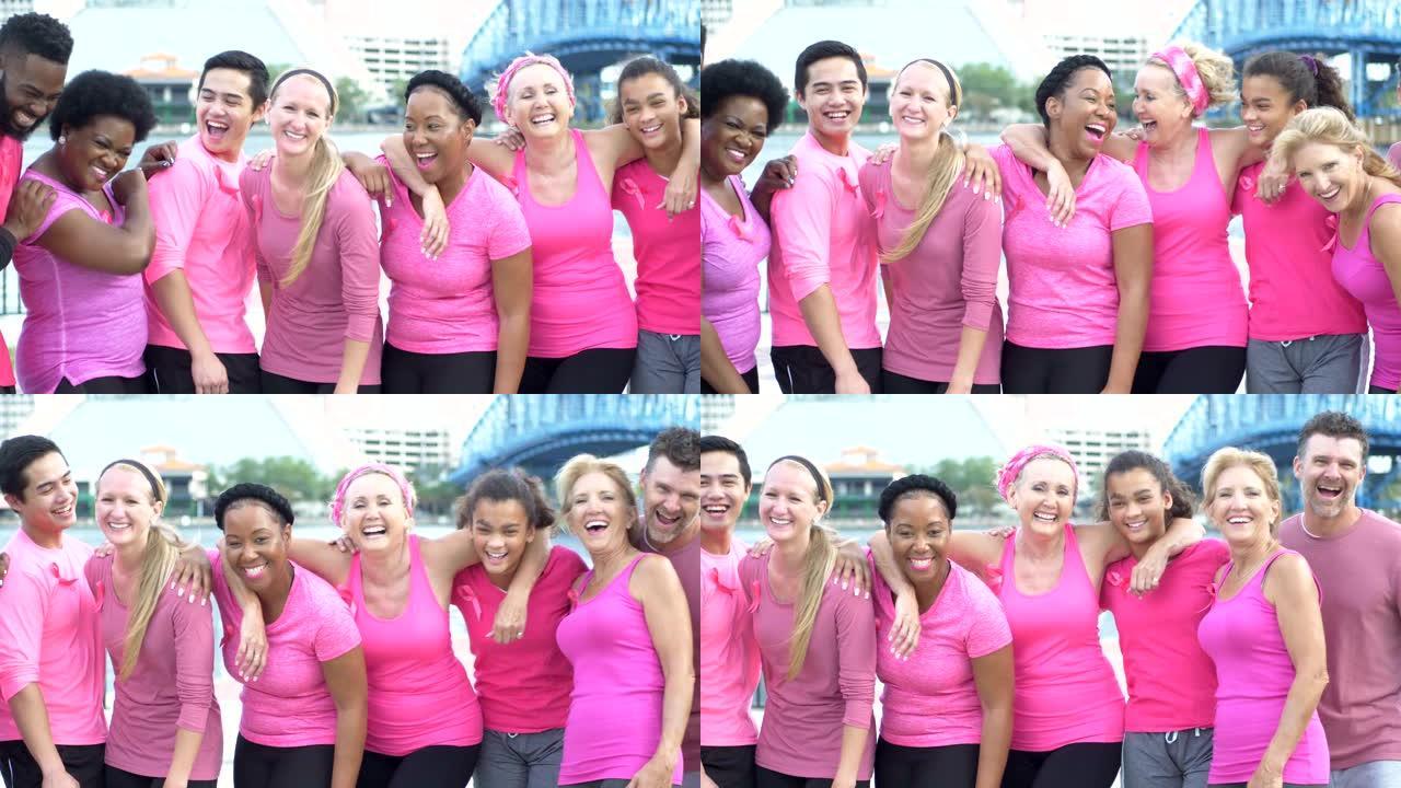 在乳腺癌宣传活动中穿着粉红色衣服的男人和女人